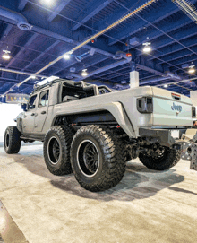 a jeep truck is on display in a showroom