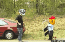 a man with a troll face on his head is standing next to a child with a pumpkin head