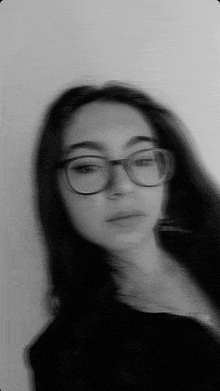 a blurry photo of a girl wearing glasses