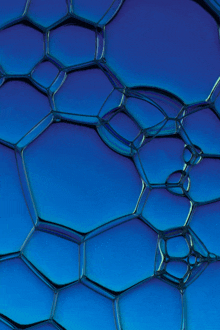 a close up of a blue soap bubble on a blue background