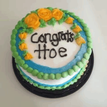 a cake that says congrats hoe on it with yellow roses