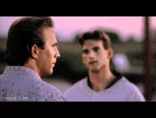 two men are talking to each other in a movie scene