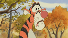 tigger from winnie the pooh is standing in the woods with trees in the background