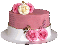 a pink and white cake with paper flowers on top of it