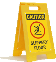 a yellow sign says caution slippery floor