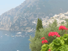 a view of a city with boats in the water and mountains in the background