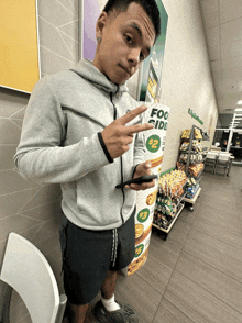 a man standing in front of a subway sign that says $ 2