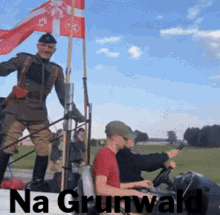 a man in a military uniform stands on top of a truck with the words na grunwald written below him