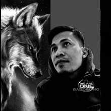 a black and white photo of a man and a wolf with the words " we are one " written on the bottom