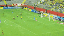 a soccer game is being played on a field with advertisements for marathon