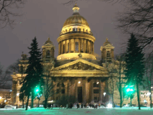 a large building is lit up at night with a dome