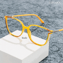 a pair of yellow glasses with rodz written on the bottom