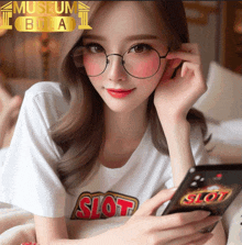 a woman wearing glasses and a shirt that says slot is looking at her phone