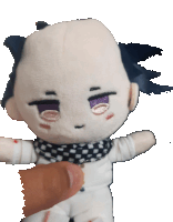 a stuffed doll with a bald head and purple eyes is being held by a person