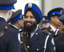 a man in a turban is smiling in a group of men