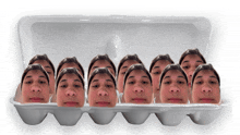 a styrofoam egg carton filled with a bunch of faces