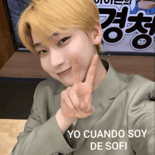 a young man giving a peace sign with the words yo cuando soy de sofi written below him