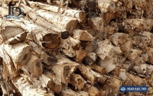 a pile of logs with a phone number on the bottom