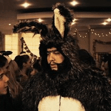 a man with a beard is dressed up as a bunny rabbit .