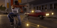 a man is riding a bike while holding a gun in front of a red car with the number 10 on it