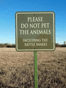 a sign that says please do not pet the animals