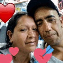 a man and a woman are posing for a picture with hearts and arrows around them .