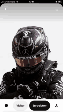 a person wearing a helmet that says petronas