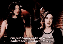 two women are standing next to each other and one of them is talking about agent morse