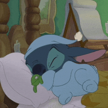 a cartoon character is sleeping on a pillow with a key in its mouth