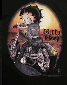 betty boop is riding a motorcycle on a black t-shirt