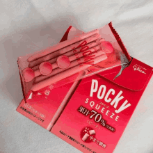 a box of pocky squeeze sits next to a pack of pocky squeeze