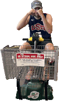 a man sitting in a shopping cart with a sign that says in-store use only