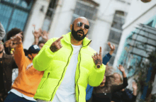 a man with a beard wearing a neon yellow jacket