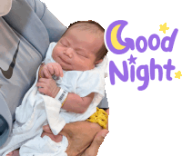 a baby is being held in someone 's arms with the words " good night " behind it