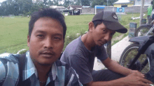 two men are posing for a picture and one of them is wearing a hat that says eagle on it