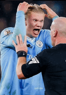 a man in a blue jersey with the number 4 on it is talking to another man