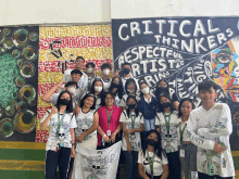 a group of people are posing in front of a wall that says critical thinkers