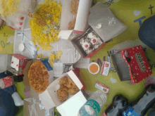 a table full of food including a box that says nicky 's