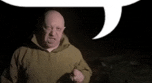 a man in a hooded jacket is talking with a speech bubble behind him