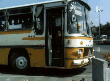 a yellow and white bus has the number 84 on the front