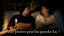 a man and a woman are laying in bed with a lit candle and the words vous faites pas la queule la