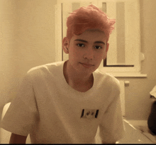 a young man with pink hair is wearing a white t-shirt that says i love