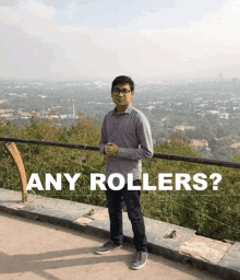 a man stands in front of a railing with the words " any rollers " above him