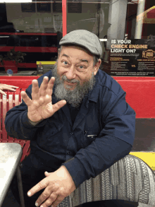 a man with a beard is sitting in front of a sign that says is your exhaust engine light on