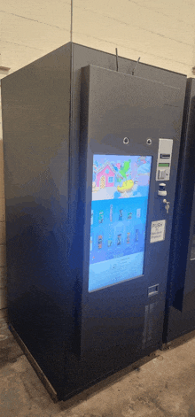 a black vending machine with a screen that says ' push here ' on it