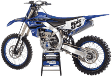 a blue dirt bike with the number 56 on the side