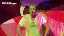 a man is covered in slime and the bbc iplayer logo is visible