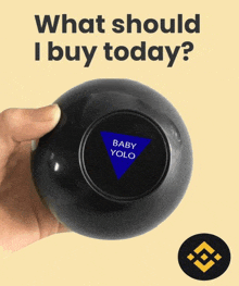 a hand holding a magic ball that says baby yolo on it