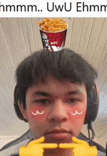 a man is wearing headphones and has a cup of kfc chicken on his head