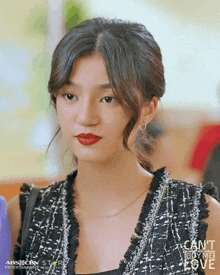 a close up of a woman wearing red lipstick and a black and white dress